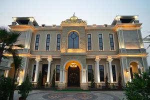 a large white building with a front door at ANNTILIA INN in Ludhiana