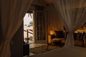 ein Wohnzimmer mit einem Sofa und Meerblick in der Unterkunft Bom Bom Principe in Principe