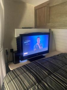 a flat screen tv sitting on top of a bed at Oak Hollow in Julian, CA in Julian