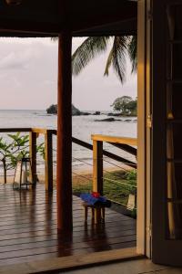 a room with a view of the ocean from a porch at Bom Bom Principe in Principe