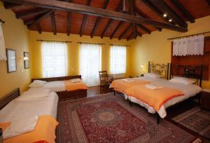 a bedroom with four beds in a room at Byron Traditional Hotel in Nafplio