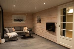 a living room with a couch and a table at Aurora panorama in Laksvatn