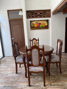 a dining room with a table and two chairs at Casa Aparicio in Buga