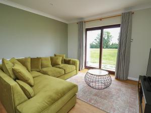 a living room with a couch and a table at Sea View in Carmarthen