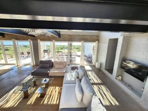 a living room with a couch and a fireplace at Mustique-Beachfront bliss in St. Helena Bay
