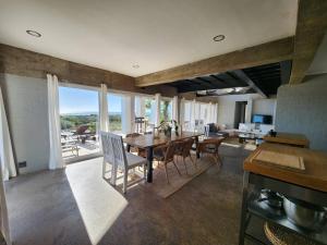 a kitchen and dining room with a table and chairs at Mustique-Beachfront bliss in St. Helena Bay