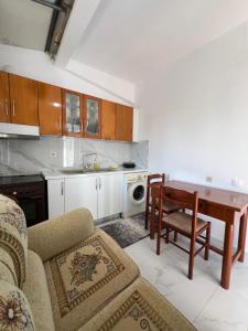 a living room with a table and a kitchen at Villa Mirjan in Sarandë