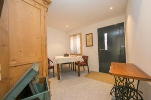 a dining room with a table and a black door at Ca' Melin - Happy Rentals in Mugena