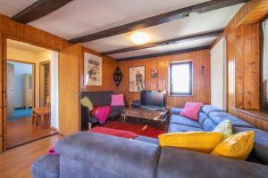 Chalet Cademario - Happy Rentals في كاريماريو: غرفة معيشة بها أريكة زرقاء وتلفزيون