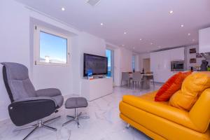 d'un salon avec un canapé et des fauteuils jaunes. dans l'établissement Yellow View Apartment - Happy Rentals, à Ronco sopra Ascona