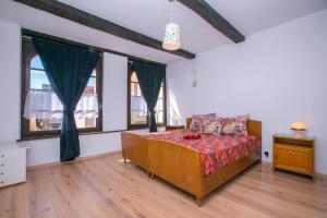 a bedroom with a bed and two windows at Chalet Cademario - Happy Rentals in Cademario