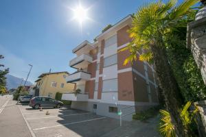 a building with a car parked in a parking lot at Charm Apartment - Happy Rentals in Ascona