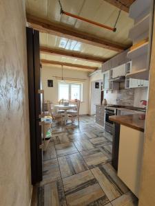 a kitchen with a table and a dining room at Apartament Zającówka - centrum miasta w leśnej enklawie in Szklarska Poręba