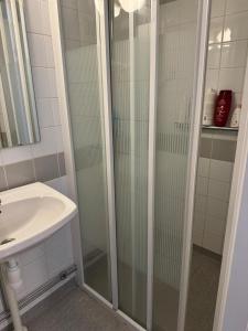 a bathroom with a shower and a sink at 2 sovrum i en del av lägenheten in Stockholm