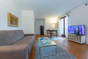 a living room with a couch and a flat screen tv at Casa Chiara - Happy Rentals in Locarno