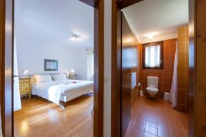 ロカルノにあるCasa Chiara - Happy Rentalsのベッドのある寝室とトイレのある浴室