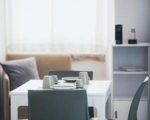 a white table and chairs in a living room at C'era una Volta Apartments in Bisceglie +6 photos