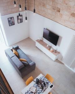 an overhead view of a living room with a couch and a tv at C'era una Volta Apartments in Bisceglie +18 photos