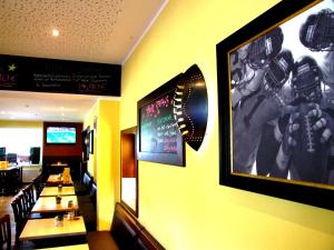 a dining room with tables and a picture on the wall at Motel Touchdown & Restaurant in Lohmar