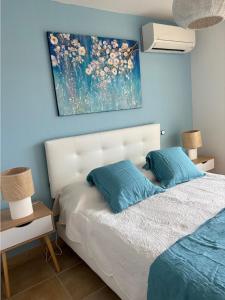 a bedroom with a bed with a painting on the wall at maria stella in Calvi