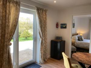 a room with a door leading to a bedroom at Clashmore Wood in Dornoch