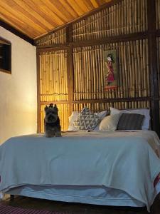 a bed with a stuffed animal sitting on top of it at Chalé na Montanha in Cunha