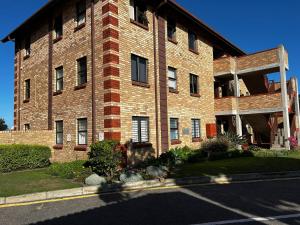 a large brick building with at Beacon Point in Mossel Bay
