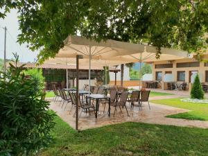 a group of tables and chairs under an umbrella at Villa Helios in Stavros +18 photos