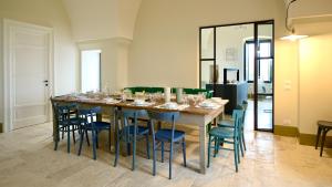 a large table with chairs and wine glasses on it at Masseria Celeste in Fasano