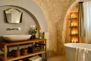 a bathroom with a sink and a bath tub at Masseria Celeste in Fasano +93 photos