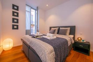 a bedroom with a large bed with two towels on it at Star of Lugano - Happy Rentals in Lugano