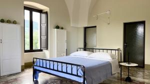 1 dormitorio con 1 cama y 2 ventanas en Masseria Celeste, en Fasano
