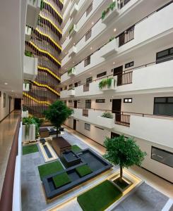 an apartment building with a courtyard with plants at Luxury Apartment Airport with Pool zona 12 Guatemala in Guatemala