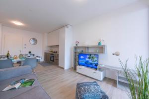 a living room with a couch and a television at Beautiful Home in Viganello