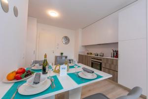 a kitchen with a table with food and wine glasses at Beautiful Home in Viganello