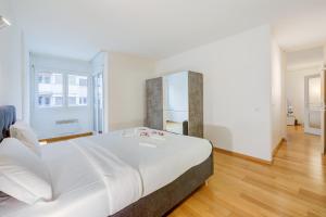 Un dormitorio con una cama grande y un espejo. en Locarno Best Place - Happy Rentals, en Locarno