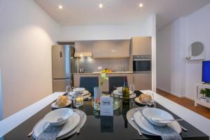 a kitchen with a table with plates and food on it at Little Lugano - Happy Rentals in Lugano