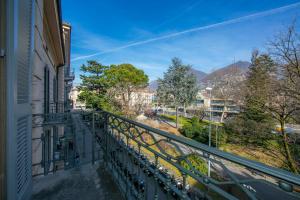 a balcony of a building with a view of a street at Little Lugano - Happy Rentals in Lugano