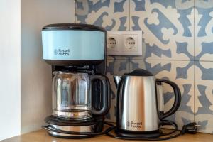 a coffeemaker and a coffee maker on a counter at Quinta das Piteiras-Turismo Rural in Silves