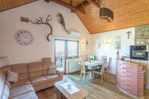 a living room with a couch and a table at Vineyard Cottage Bahor - Happy Rentals in Črnomelj