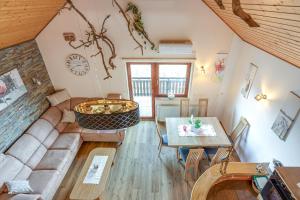 a living room with a couch and a table at Vineyard Cottage Bahor - Happy Rentals in Črnomelj