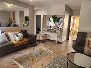 a living room with a couch and a table at Lemon tree in Pretoria