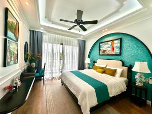 a bedroom with a large bed and a ceiling fan at Ký ức Đông Dương in Quang Ninh