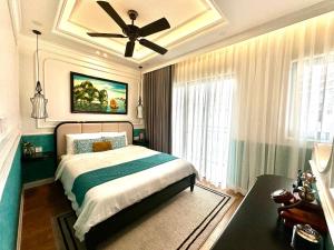 a bedroom with a bed and a ceiling fan at Ký ức Đông Dương in Quang Ninh