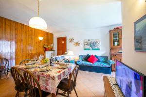 een woonkamer met een tafel en een bank bij Bramé La Fam 32 few steps from skiing - Happy Rentals in Bardonecchia