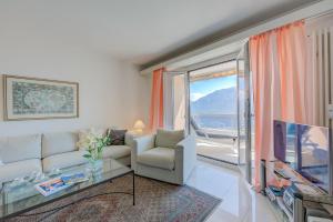 a living room with a couch and a tv at Casa Monti Belvedere in Locarno