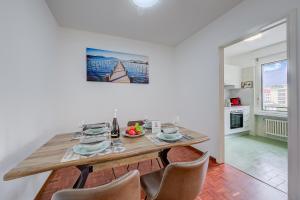 a kitchen and dining room with a table and chairs at Lido Apartment in Locarno