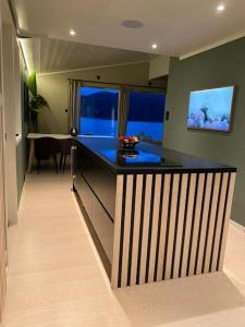 a kitchen with a black counter top in a room at Aurora panorama 2nd floor in Laksvatn