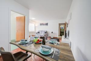 - une salle à manger et un salon avec une table et des chaises dans l'établissement Lido Apartment, à Locarno