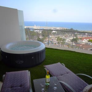 a hot tub on the balcony of a building at Aphrodite Heights in Larnaka